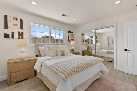 a bedroom with a large bed and a window