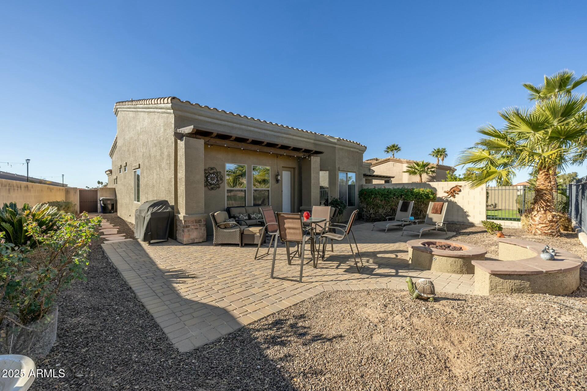 6202 East McKellips Road, Unit 91 Mesa, AZ 85215 - Photo 1 of 42 a view of a patio with table and chairs potted plants and floor to ceiling window