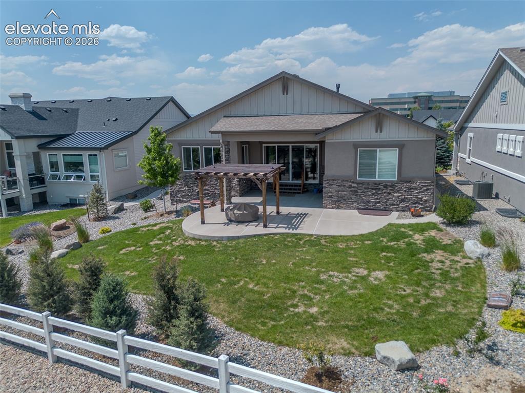 1061 Native Dancer Terrace Colorado Springs, CO 80921 - Photo 48 of 50 Rear exterior featuring a concrete patio, wood pergola, and a built-in fire pit