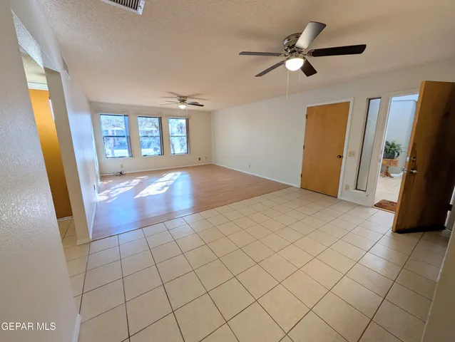 a view of an empty room and a window