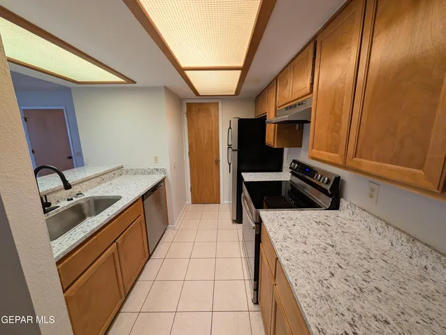 a kitchen with a sink stove and cabinets