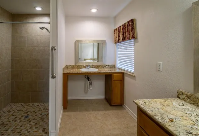 an empty room with closet and a chandelier fan