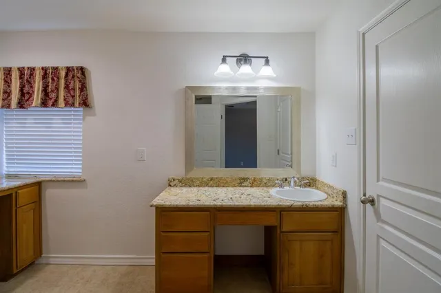 an empty room with a fan and a fan