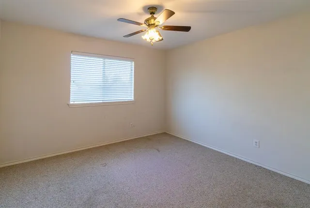 a front view of a house with a yard and lake view