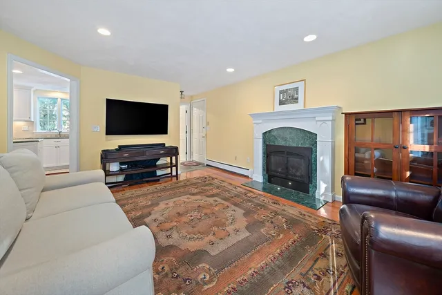 a view of a dining room with furniture a chandelier and wooden floor
