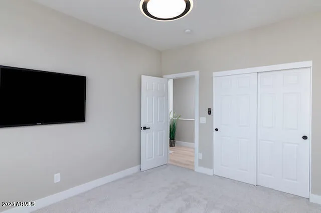 a view of a livingroom with wooden floor and a flat screen tv