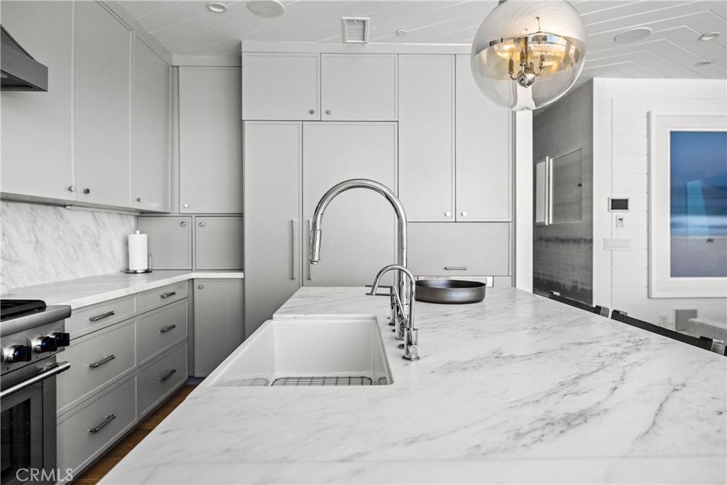2200 The Strand, Unit B Manhattan Beach, CA 90266 - Photo 12 of 35 a kitchen with stainless steel appliances granite countertop a sink a stove and cabinets