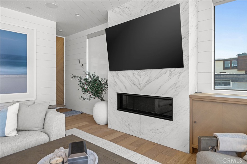 2200 The Strand, Unit B Manhattan Beach, CA 90266 - Photo 13 of 35 a living room with furniture a flat screen tv and a fireplace