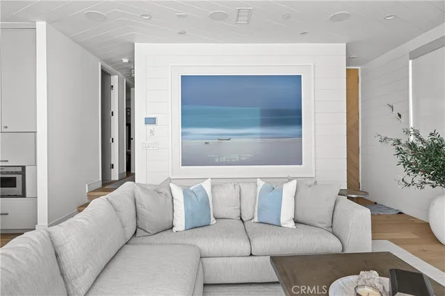 a kitchen with a counter space a sink and a flat screen tv