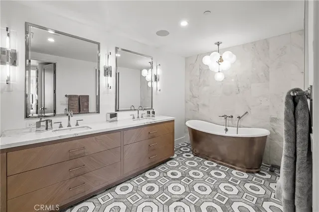 a bathroom with a double vanity sink mirror and shower