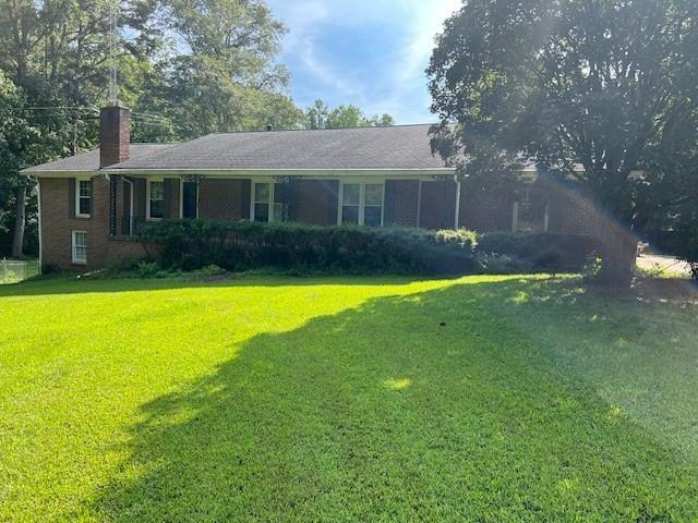 3415 Lake Carlton Road Loganville, GA 30052 - Photo 2 of 6 a view of a house with a swimming pool and a yard