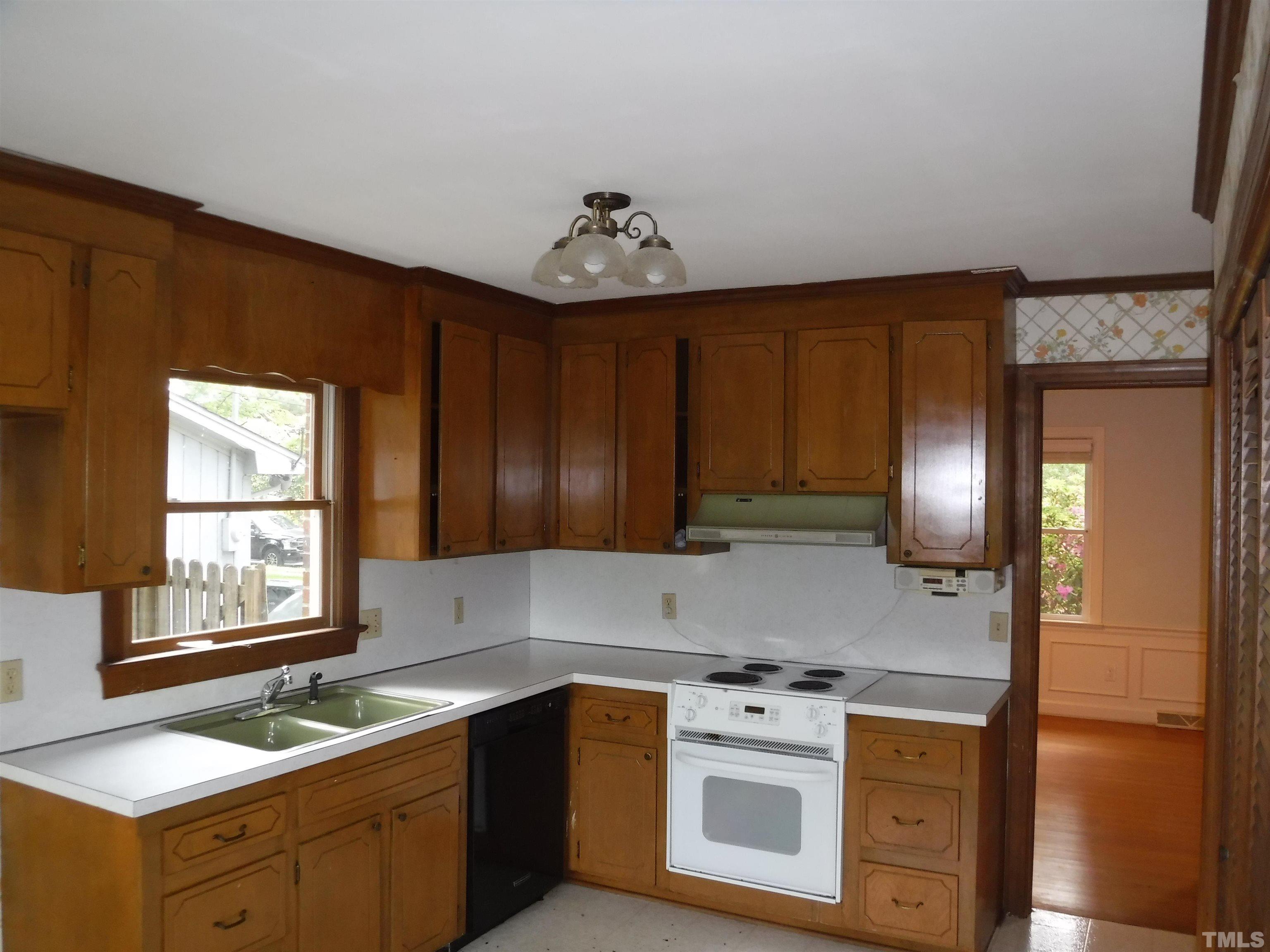 1008 Deerfield Road Raleigh, NC 27609 - Photo 14 of 18 a kitchen with stainless steel appliances granite countertop a sink stove and refrigerator