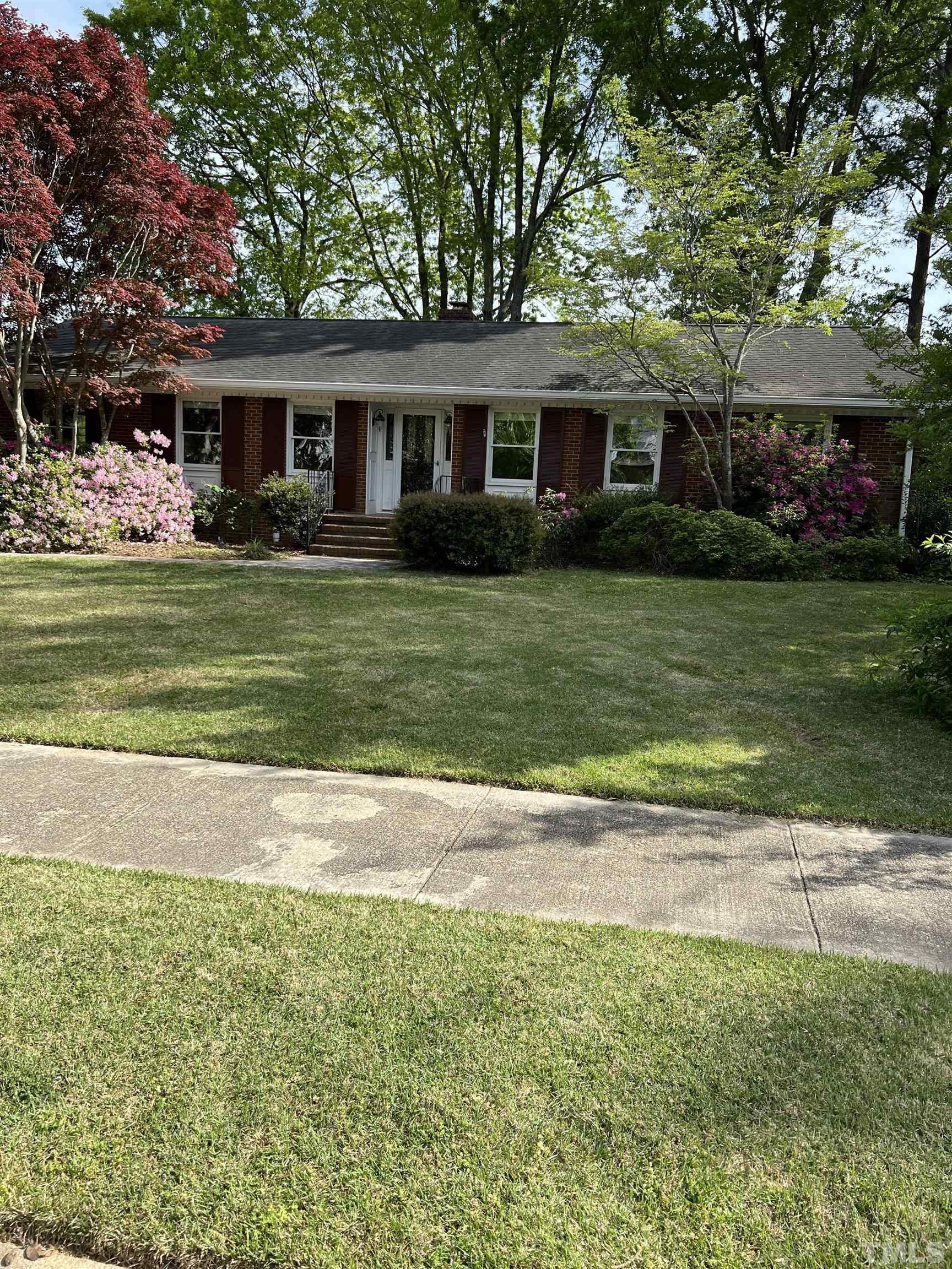 1008 Deerfield Road Raleigh, NC 27609 - Photo 2 of 18 a front view of a house with a garden