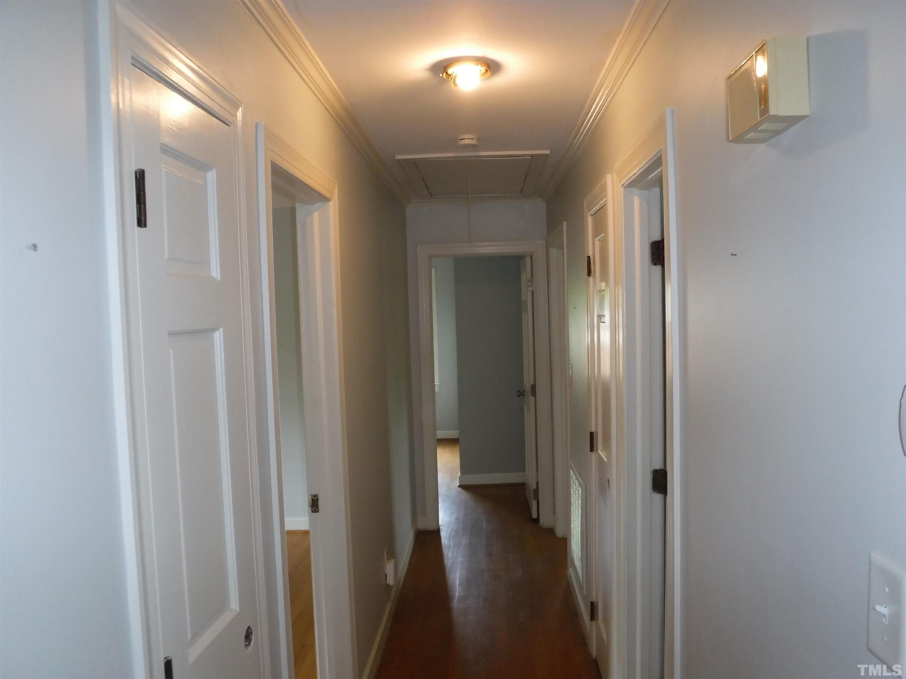 1008 Deerfield Road Raleigh, NC 27609 - Photo 7 of 18 a view of a hallway with a wooden door