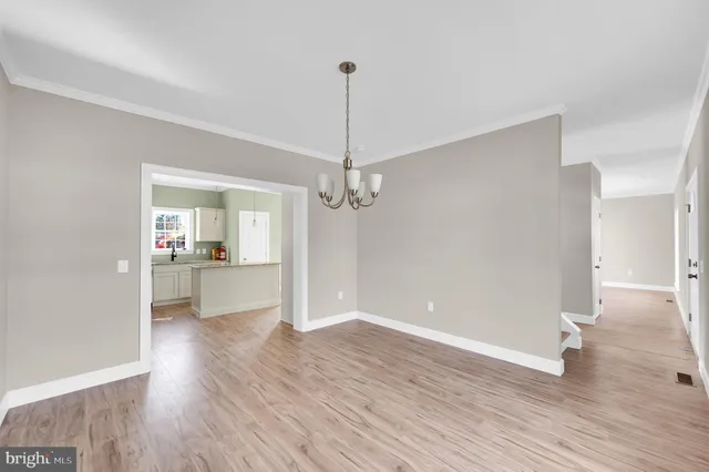 a view of a kitchen with wooden floor and a kitchen