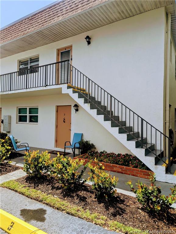 2950 Southeast Ocean Boulevard, Unit 56 Stuart, FL 34996 - Photo 2 of 12 a view of a house with a yard