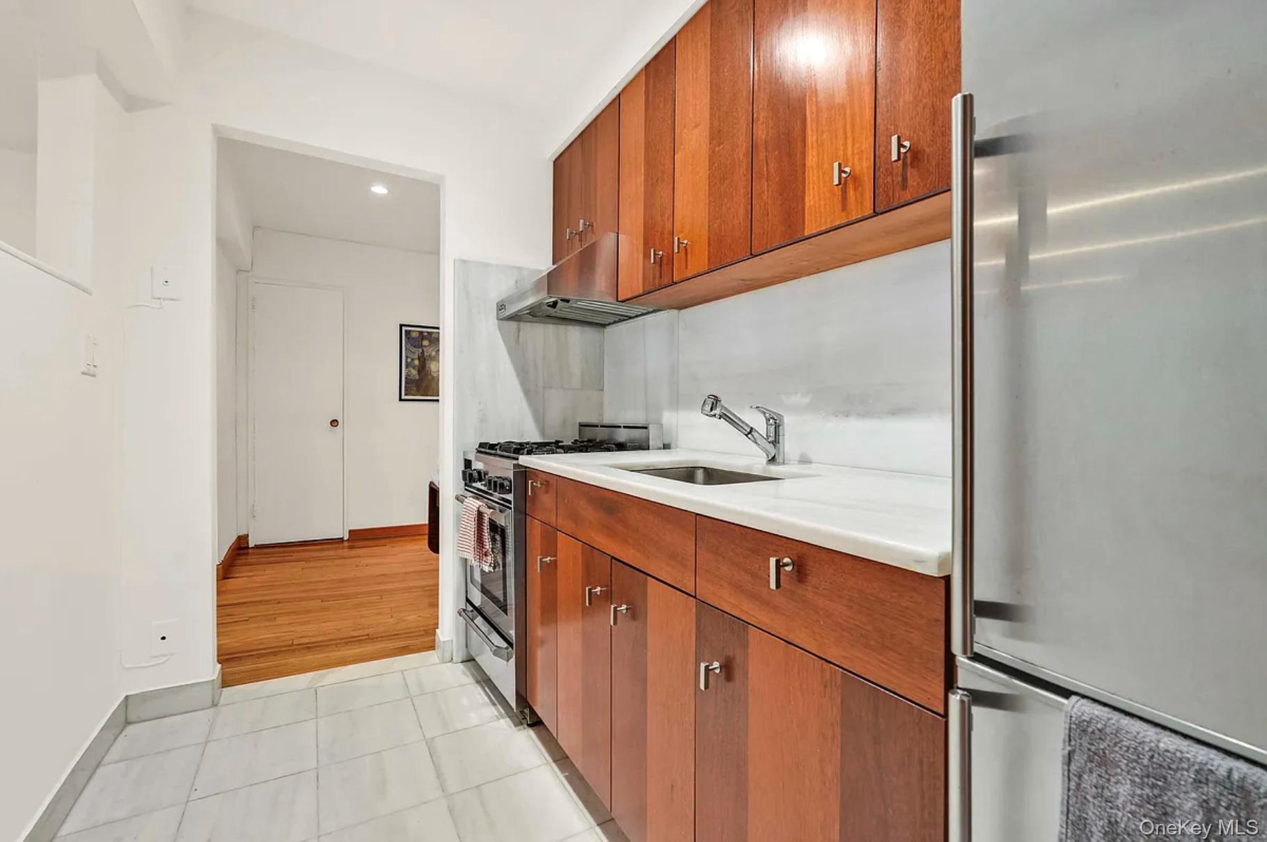 30-44 29th Street, Unit 6D Queens, NY 11102 - Photo 3 of 15 a kitchen with a sink and cabinets