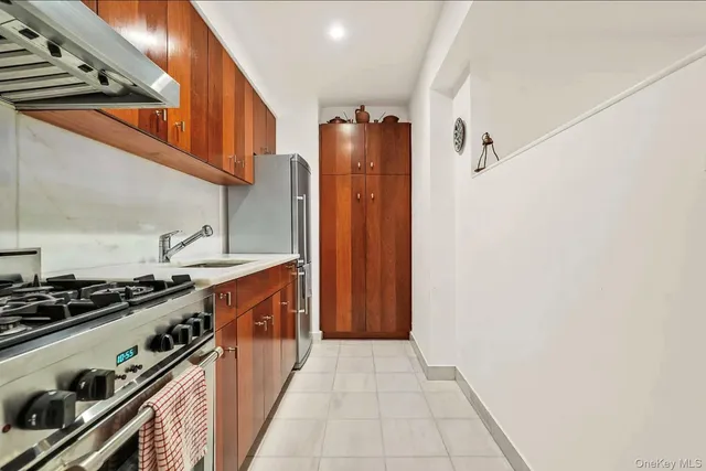 a kitchen with stainless steel appliances granite countertop a stove and a sink
