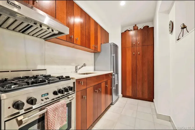 a kitchen with stainless steel appliances granite countertop a stove and a refrigerator