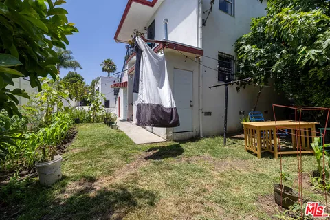 a backyard of a house with table and chairs