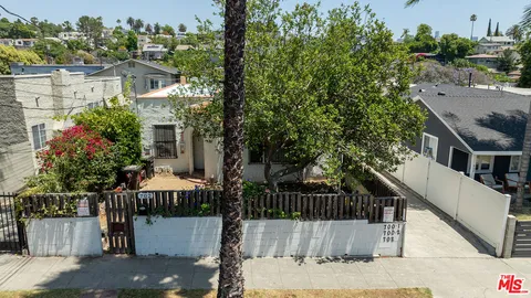 a view of street along with house and trees