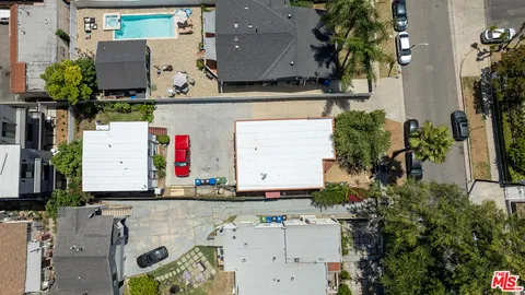 an aerial view of residential houses with outdoor space