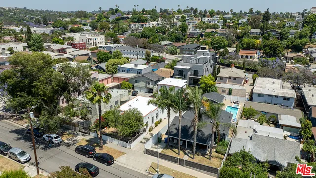 an aerial view of residential houses with outdoor space