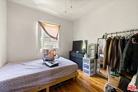 a bedroom with a bed and a flat screen tv