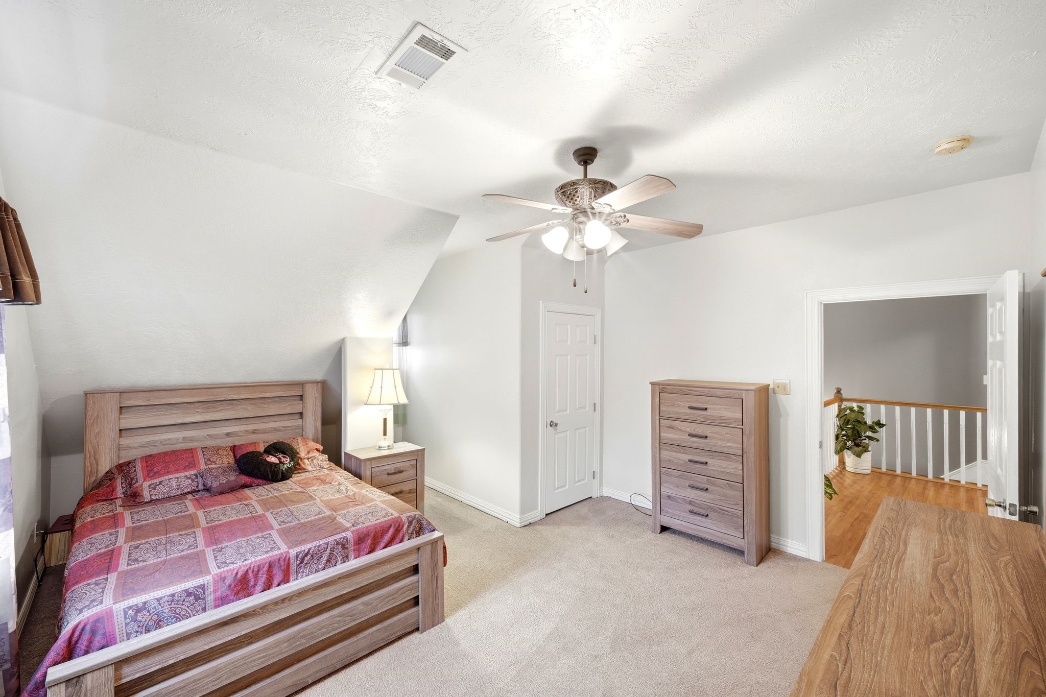 144 Wood Farm Road Huntsville, TX 77320 - Photo 27 of 50 a bedroom with a bed and a chandelier