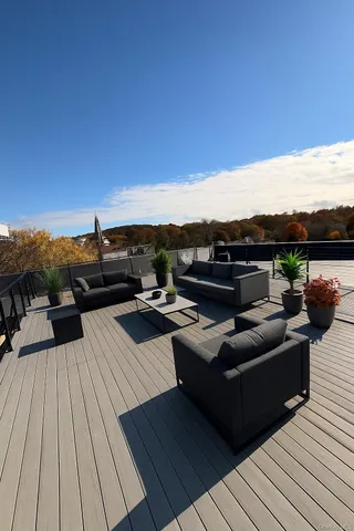 a view of a terrace with couches and sky view