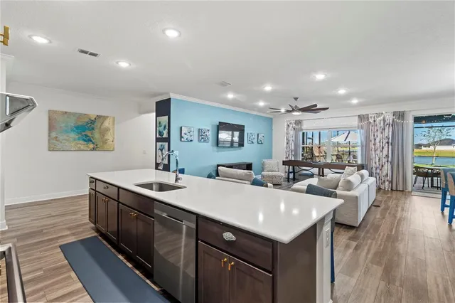 a kitchen with stainless steel appliances granite countertop a refrigerator and a sink