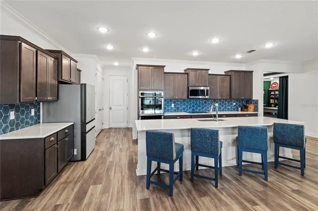 a kitchen with stainless steel appliances granite countertop a refrigerator and stove