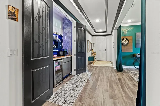 a living room with furniture kitchen view and a large window