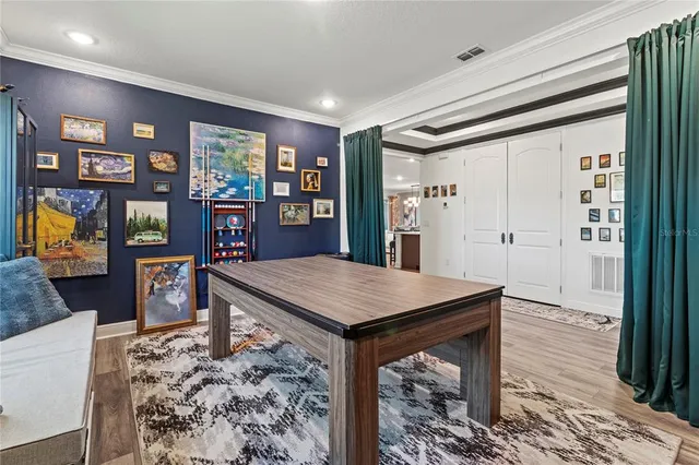 a bedroom with furniture and a large window