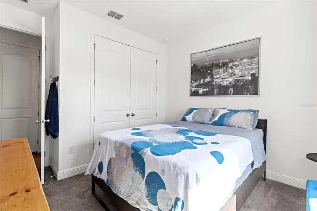 a view of a big house with a big yard and large trees