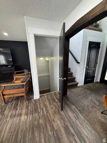 1237 South 260 West Payson, UT 84651 - Photo 39 of 81 Wood-finish flooring, dark wood-tone accent beam, white trim, and a dark paneled door