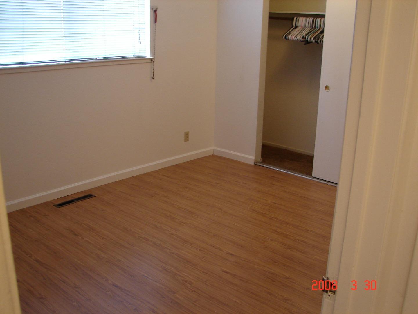 431 East St John Street San Jose, CA 95112 - Photo 11 of 32 a view of an empty room with wooden floor and a window