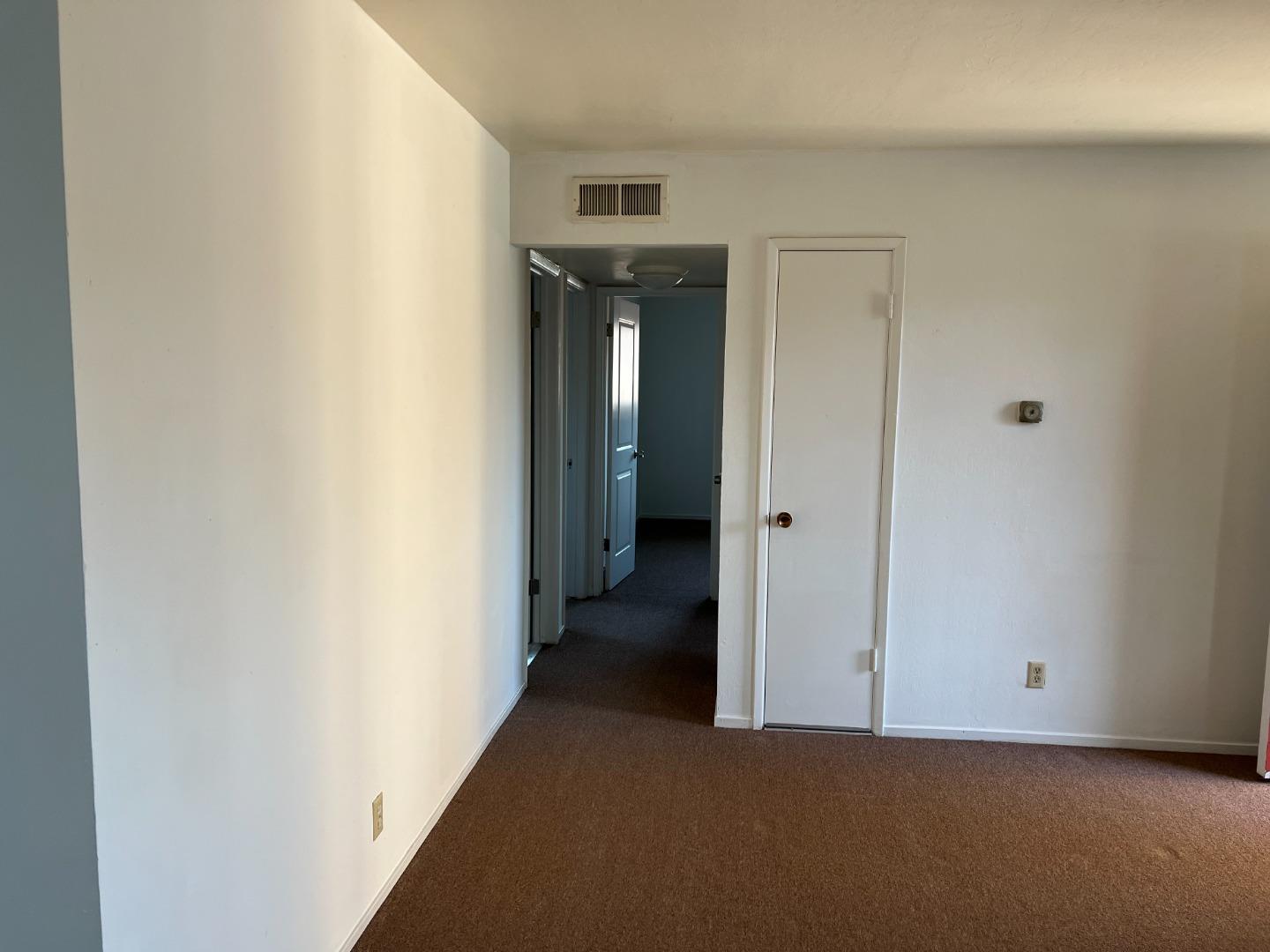 431 East St John Street San Jose, CA 95112 - Photo 14 of 32 a view of a hallway with wooden shelves