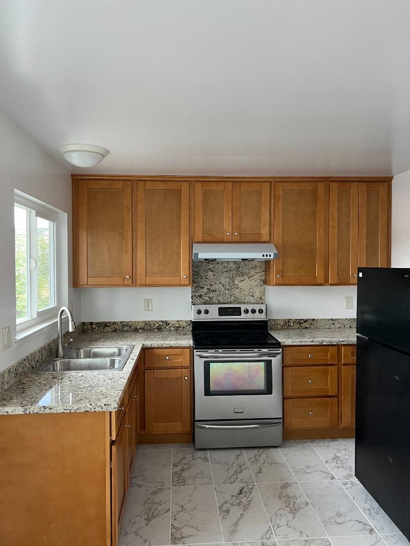 431 East St John Street San Jose, CA 95112 - Photo 3 of 32 a kitchen with granite countertop a sink stove and cabinets