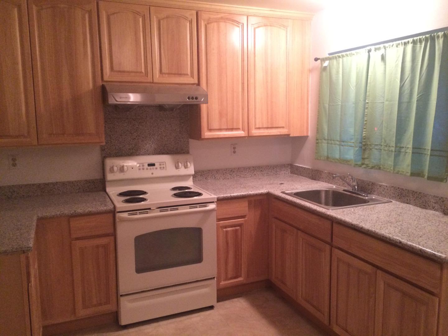 431 East St John Street San Jose, CA 95112 - Photo 5 of 32 a kitchen with granite countertop a sink a stove and cabinets
