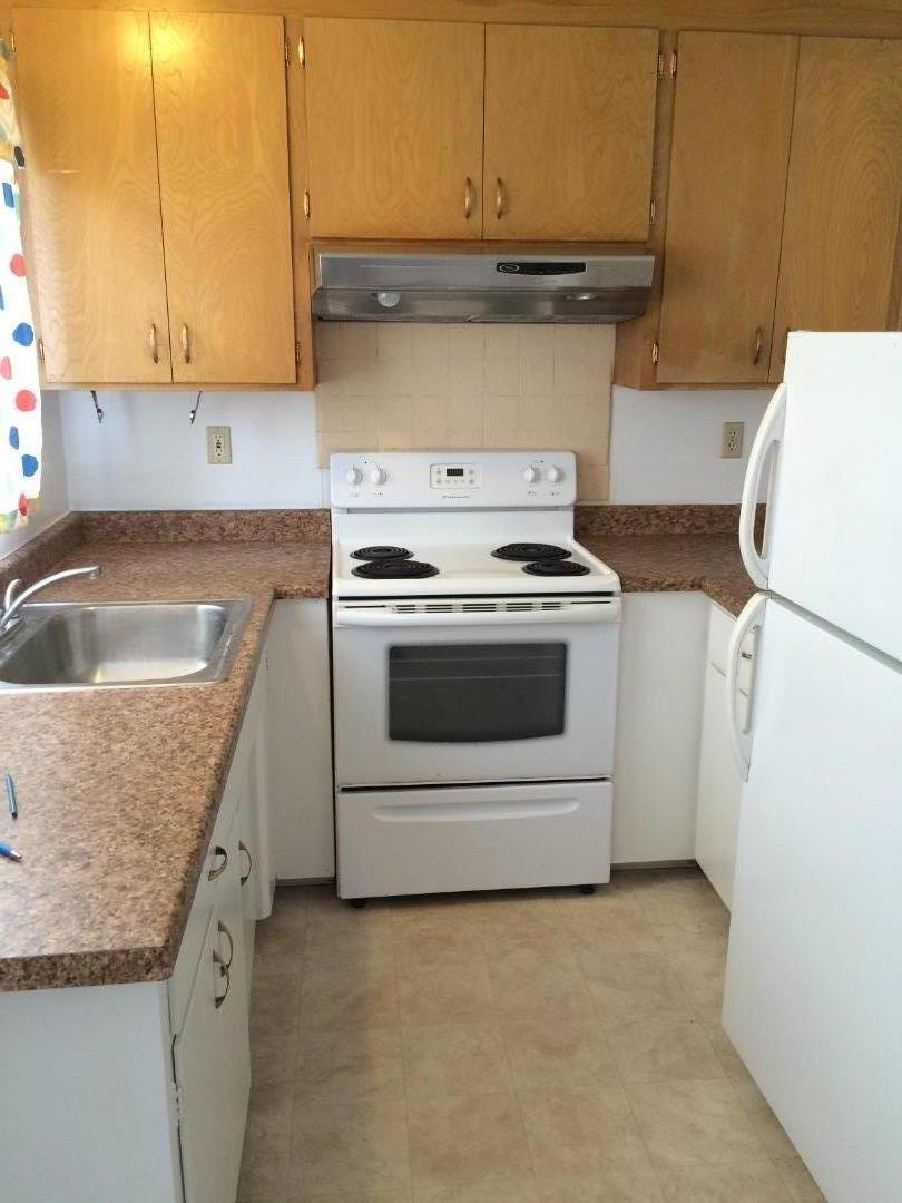 431 East St John Street San Jose, CA 95112 - Photo 6 of 32 a kitchen with granite countertop a sink a stove and cabinets