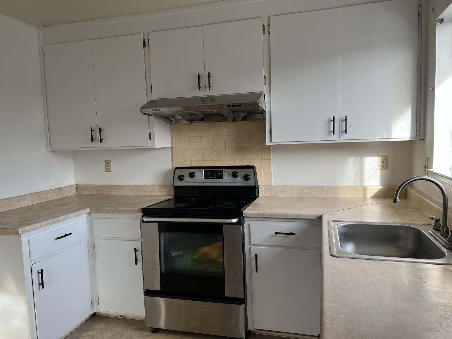 431 East St John Street San Jose, CA 95112 - Photo 7 of 32 a kitchen with cabinets appliances and a sink