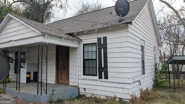 a view of a house with a door and wooden walls