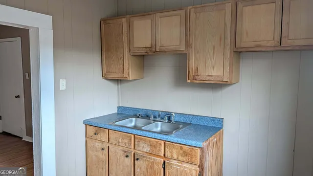 a kitchen with white cabinets a sink and dishwasher