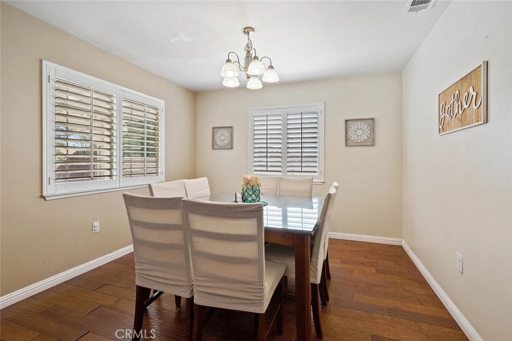 14022 Arlee Place Sylmar, CA 91342 - Photo 15 of 33 a view of a dining room with furniture window and wooden floor