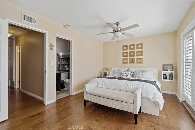 a spacious bedroom with a bed and a chandelier
