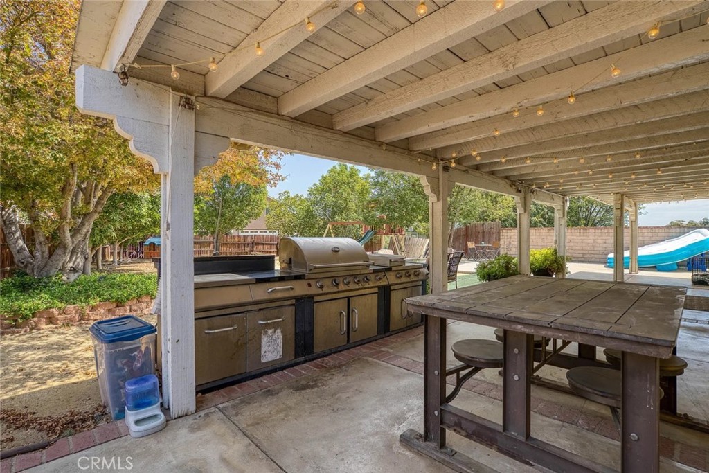 14022 Arlee Place Sylmar, CA 91342 - Photo 25 of 33 a view of a patio with a table chairs and a backyard