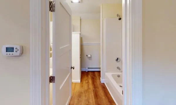 a bathroom with a bathtub and a shower
