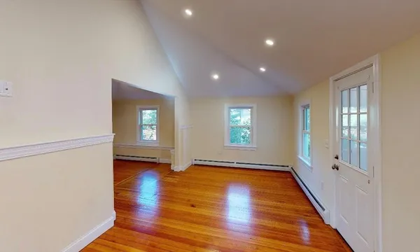 a view of a livingroom with wooden floor and window