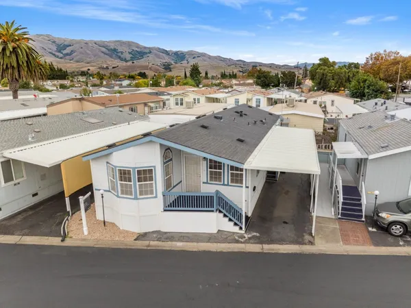 an aerial view of residential houses with outdoor space